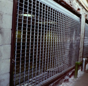 Straight link pattern grille motorized coiling security gate. Steel and aluminum reverse mounted. (Brooklyn NY)
