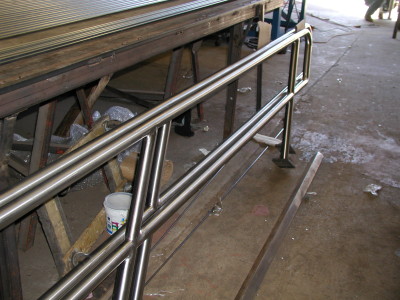 Polished stainless steel pipe railing w/ base plate. (Queens, NY)