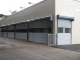 Chain operated storefront rollup security gates with 24" straight link aluminum grille inserts. (Queens NY)
