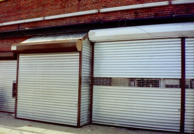 Solid manual roll down security gates with 12’’ grilles insert and steel filler panels for built out vending area. (Brooklyn NY) 1 of 2