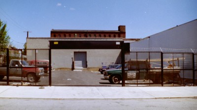 Expanded metal mesh welded steel fence with motorized roll down coiling gate with barded wire and razor ribbon for parking lot. (Brooklyn, NY) 1 of 2