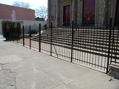 Simple 6' welded steel bar fence with scalloped top and 2” tube steel parts and welded caps. (Queens, NY)