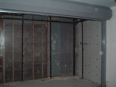 Frame less expanded metal mesh bolted to structural steel support tubes with solid roll down gate for storage room with roof. Different gauges and spacing available. (Brooklyn, NY)