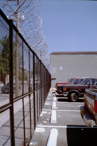 8' expanded metal and angle iron welded fence parels mounted to fence posts with 24" cement footing and razor ribbon. (Brooklyn, NY)