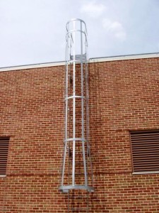 25 foot exterior roof ladder with steel cage. Galvanized with platform over parapet. (Queens, NY)