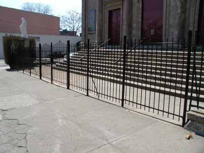 Simple 6′ welded steel bar fence with scalloped top and 2” tube steel parts and welded caps. (Queens, NY)