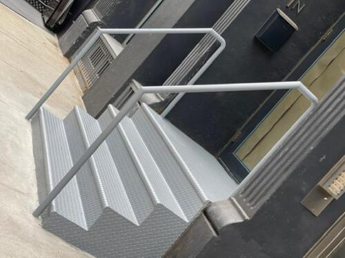 Closed tread diamond plate custom metal stairs endcaps pipe railing, Soho new york city